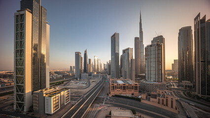 Fototapeta na wymiar Aerial view of Dubai Downtown skyline during sunrise with many towers timelapse.