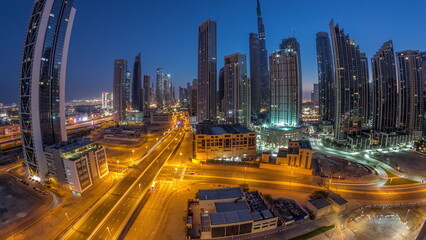 Fototapeta na wymiar Aerial panorama of Dubai Downtown skyline with many towers night to day timelapse.