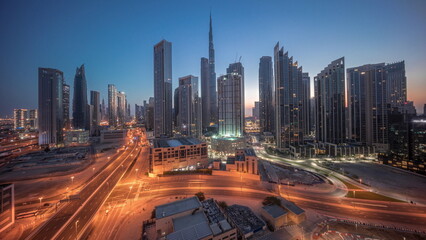 Aerial view of Dubai Downtown skyline with many towers night to day timelapse.