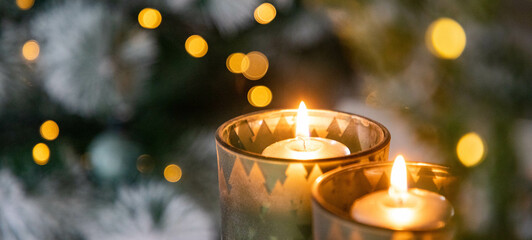 burning Christmas candles and bokeh light