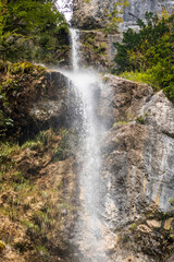 Fototapeta premium Creek and huge waterfall in mountain at Tolmin in Slovenia.