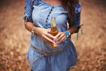 Hands of woman at music festival with nature, beer and relax in woods for concert event. Alcohol,...