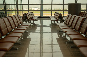 Empty airport terminal waiting area airport passenger terminal with empty seats in the departure lounge