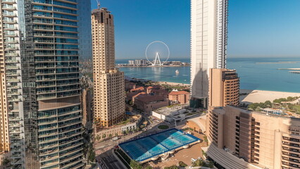 Panoramic view of the Dubai Marina and JBR area and the famous Ferris Wheel aerial timelapse