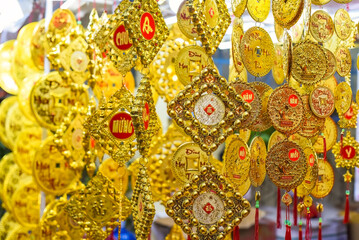 many decorations as symbol of wealth in the market for Tet Lunar New Year vietnamese language translated as 