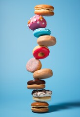 Colorful donuts levitate on a blue background. Concept of fast food.