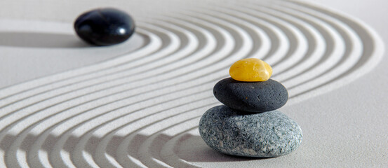 Japanese zen garden with stone in white textured sand