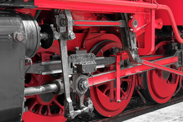 Close-up of red wheels of an old steam train locomotive - 689618176