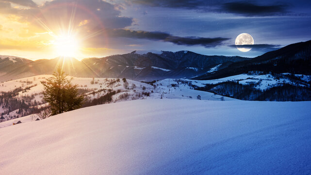 mountainous winter landscape in morning light. solstice scenery with snow covered rolling hills in the distance beneath a sky with sun and moon. day and night time change concept