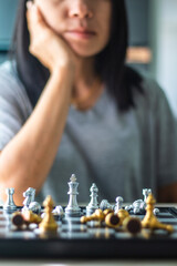 woman playing chess board game for relaxing. Chessboard game for ideas and competition. Close-up photo.