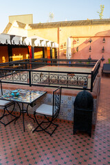 Upper terrace of a Riad.
Typical Moroccan house, with lots of decoration on the terrace. Sunny morning.