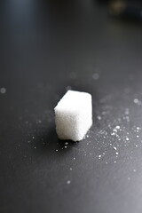 Sugar cubes black Background background iluminated sweet food