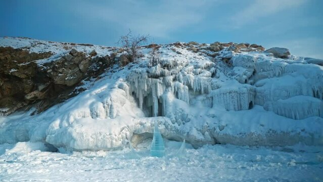 Ice sculpture stairs leading to snow grotto. Ice Sculpture Festival on Olkhon Island. A winter fairy tale. A figure of stairs. Lake Baikal, Siberia, Russia.