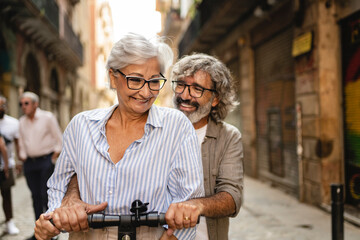 joy and happiness for an adult married couple having fun traveling on the same bicycle having a fun...