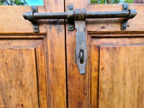 evocative image of an old rusty lock on a country house door