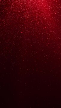Looped animated abstract background of red light rays and falling particles in vertical composition format