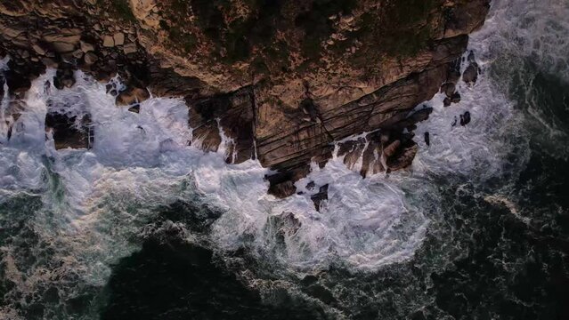 Aerial view of waves breaking along the coastline at Cape of Good Hope National Park and Natural Reserve, Cape Town, Western Cape, South Africa.