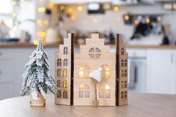 Key and tiny house of a small size on cozy home with Christmas decor on table of festive white...