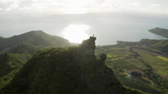 Aerial view of a person on top of Le Chat et La Souris mountain or Mount Villars, in the Bambous Range near Grand Sable, Flacq, Mauritius.