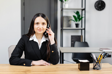 Call center agent with headset working on support hotline in modern office. Video conference.