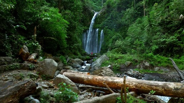 Aerial view of a person along the small river in Tiu Kelep Waterfall, Senaru Lombok, Indonesia.