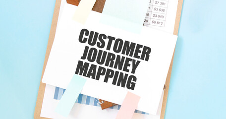 Paper plate with text take CUSTOMER JOURNEY MAPPING. Diagram, notepad and blue background