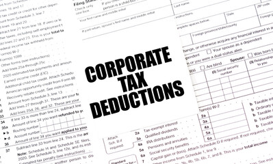 CORPORATE TAX DEDUCTIONS on white sticker with tax forms