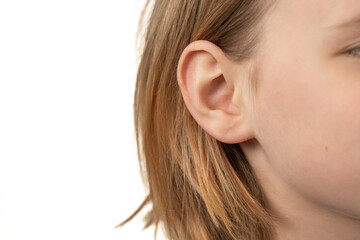 ear of a young child close-up on a white background - obrazy, fototapety, plakaty