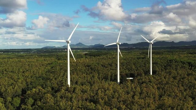 Aerial drone view of windmills in the tropical forest, La Plaine des Roches, Mauritius.