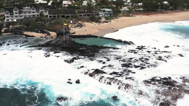 Aerial drone view of the coast of Boucan Canot with its natural pool on a cloudy day, Boucan Canot, Saint-Paul, Reunion.