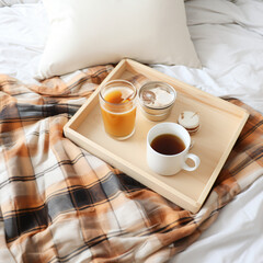 Fototapeta na wymiar Tray of coffee and candles with warm plaid on white 