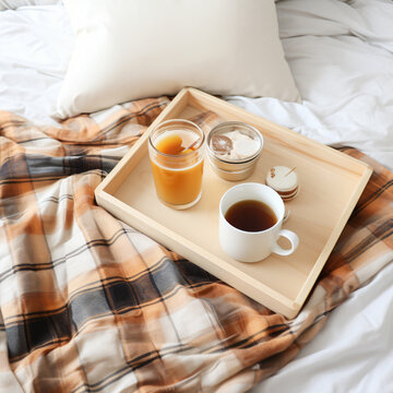 Tray of coffee and candles with warm plaid on white 