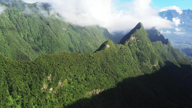 Panoramic aerial drone view of Cirque de Salazie with Piton d'Anchaing and Piton des Neiges in the background, Saint Andre, Reunion.