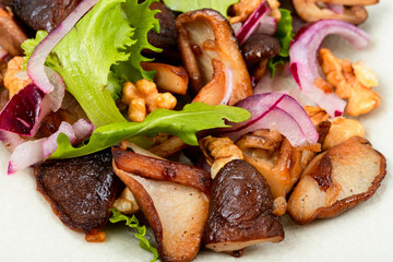 Mushroom dietetic salad with onions and walnuts.