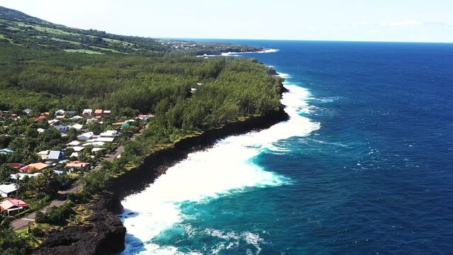 Aerial drone view of Puits des Anglais with an empty pool, natural pool and high breaking waves, Saint-Philippe, Reunion.