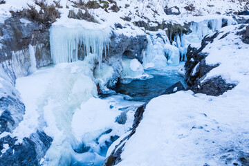 Frozen waterfall Jily Su in winter. Landscape of mountains with a waterfall. Caucasus, Russia