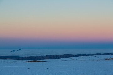 Sunset in snowy valley in Caucasus mountains, Russia. Background