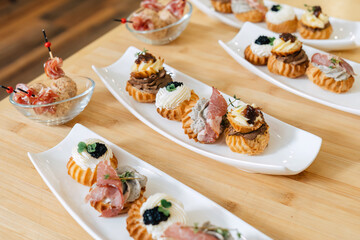Luxury catering, profiteroles with various fillings. Ham, meat, cream cheese, pates.