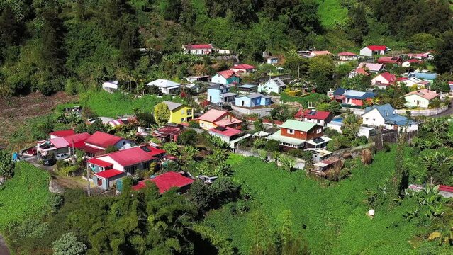 Aerial drone view of a creole village with colourful houses, Cirque de Salazie, Reunion.