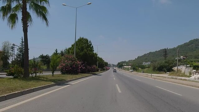 highway road in the countryside, roadside and asphalt, green trees and mountains 