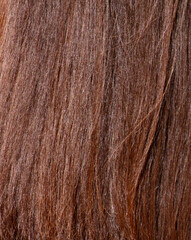 Brown straight hair as an abstract background. Texture