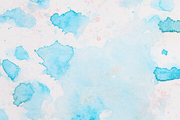 Abstract liquid art background. Blue watercolor translucent blots on white paper.