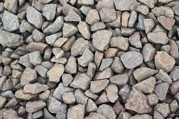 Large stones of different shapes close-up. there are a lot of small stones nearby