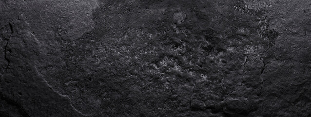 Black stone texture, dark abstract background. Natural mineral rock close up details, empty...