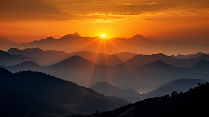 A mountain range that is majestic and has a tranquil sunset silhouette.