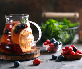 refreshing drink tea in a glass teapot on the table