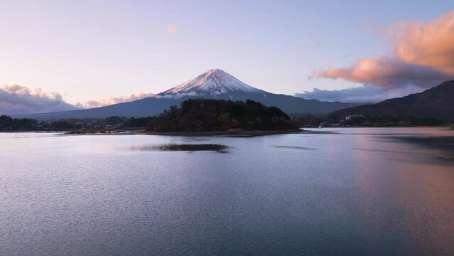 aerial view drone of mount fuji at sunrise,flying low over lake water sunny autumn day