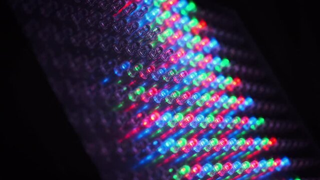 LED panel with many RGB luminous semiconductor diodes, close-up. LED-dots light panel with different effects. Background of red, green, and blue light-emitting diodes. Macro shot of multicolored RGB