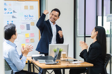Man professional celebrate with colleague in conference room. Group of colleagues celebrating success in a meeting