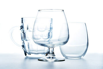 Glass goblet, tumbler and mug. Set of clean, clear bar glassware for alcohol.